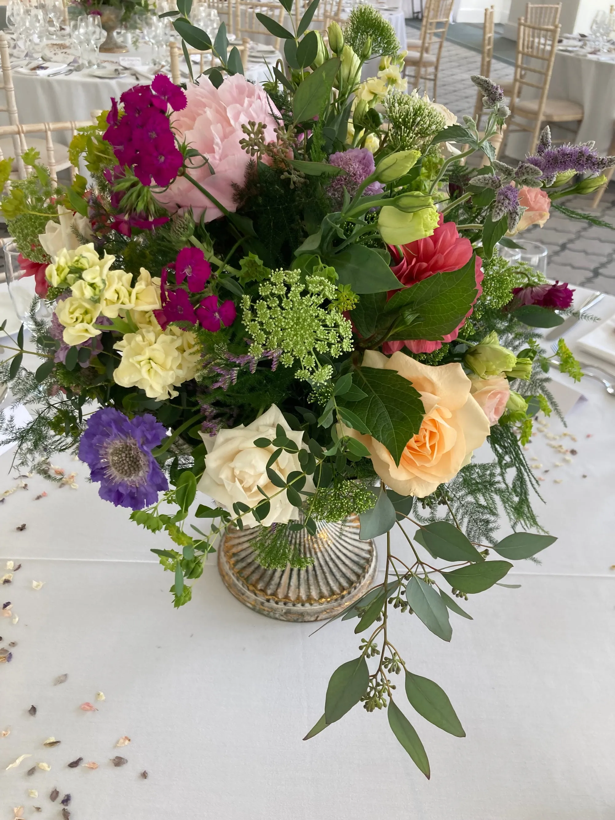 A pedestal arrangement in pinks, peach and lilac
